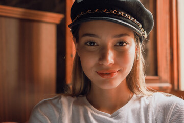 A woman wearing a black hat and smiling