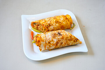 Lavash doner kebab ( soslu kasarli zurna doner durum )  or shawarma sliced in plate isolated.  Tavuk Et Doner Durum. Hatay Iskenderun usulu bazuka tavuk doner durum.