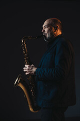 Naklejka premium Saxophonist in Spotlight Creating Melodic Harmony