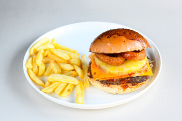 Big tasty burger with beef cutlet on a plate. Hamburger, cheeseburger with mushroom. Hamburger, Mexica, mushroom double burger.  Crispy chicken burger. With french fries, patates kizartmasi.