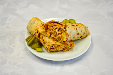 Lavash doner kebab ( soslu kasarli zurna doner durum )  or shawarma sliced in plate isolated. ...