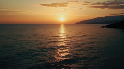Fototapeta premium Serene Sunset Over the Ocean with Calm Waves and Cloudy Sky in Warm Tones 1920x1080 PNG