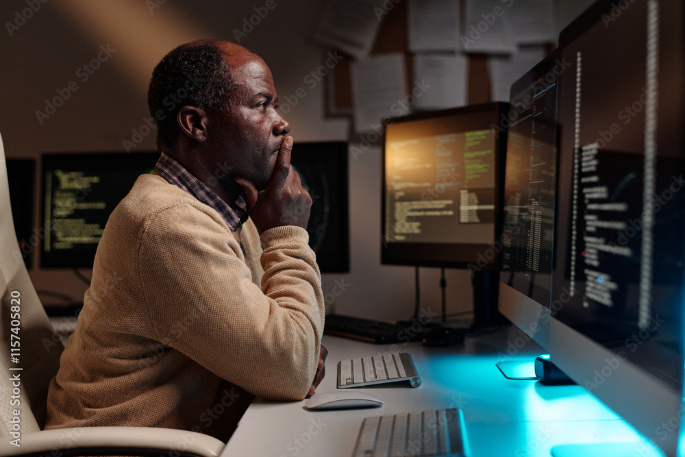 Aufkleber Mature African American IT manager trying to solve technical problem or decoding data while looking at desktop computer screen