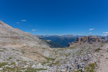 Summer panorama of the dolomite rocky plateau of the Latemar Massif. Pale di San Martino and Mount Civetta in the background. UNESCO world heritage site, Trentino-Alto Adige, Italy, Europe