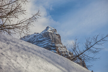Detail of the beautiful and majestic north face of Mount Pelmo in winter conditions that comes out behind a snowy slope. Fiorentina Valley, Dolomites, Italy