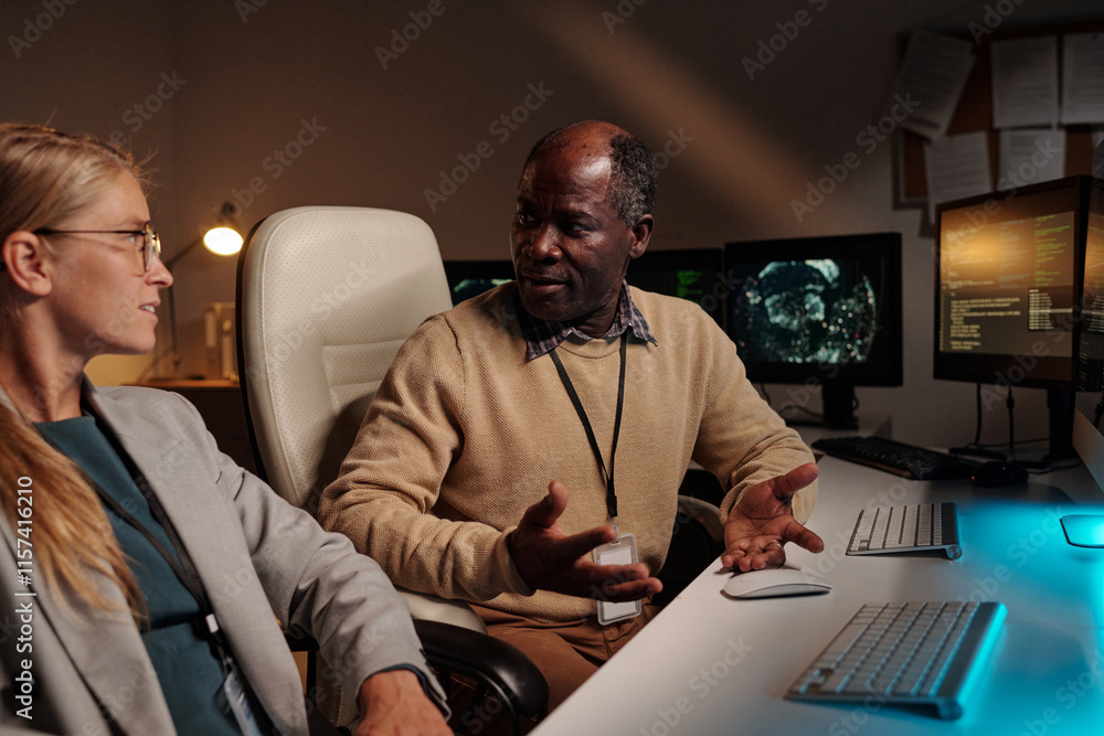 Poster confident male programmer explaining ways of decoding data to blond female colleague during conversa