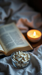 A cozy nighttime scene featuring a book and glass bowl filled with magnesium tablets on a bed.