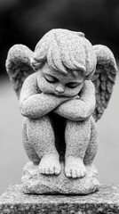 Granite Statue of a Seated Winged Cherub