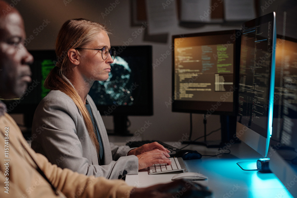 Poster Young blond IT support manager typing on desktop computer keypad and looking at screen while decoding online data