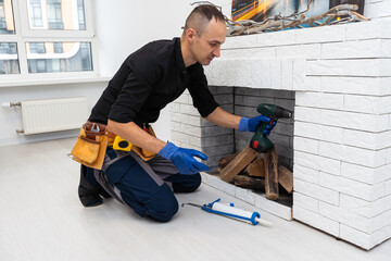 Fireplace installing in white brick wall.