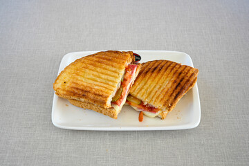 Turkish karisik atom kare  tost ( kasarli bazlama tost) . Sucuklu, Kasarli,  cheddarli, kavurmali karisik tost. Flat baked bread toasted. Karisik bazlama tost .