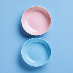 Pink and blue bowls on blue background.