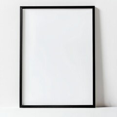 A Clean Canvas: A black picture frame is mounted against a backdrop, showcasing an empty space for art or photography, offering a minimalist aesthetic.