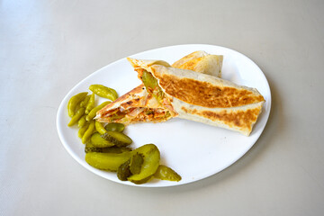 Lavash doner kebab ( soslu kasarli zurna doner durum )  or shawarma sliced in plate isolated.  Tavuk Et Doner Durum. Hatay Iskenderun usulu bazuka tavuk doner durum.