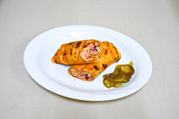 Lavash doner kebab ( soslu kasarli zurna doner durum )  or shawarma sliced in plate isolated. ...