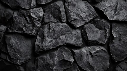 Dark grey stone wall texture. Rough, uneven surface of natural rocks.