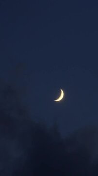 Crescent Moon and Planet Venus in Astronomical conjunction time lapse in blue night sky.  vertical video for social media. 
