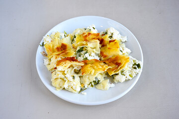 Turkish style meat stuffed filo dough borek served kol boregi.Cheese and minced pie are sliced on a marble background. Turkish name: Kol Boregi, kiymali, peynirli su boregi. Ci borek. Kafkas cig borek