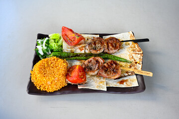 Famous Urfa meat liver, ciger wrapped by lavash with roasted chili pepper, onion and sauce in Sanliurfa, Turkey. Kuzu et ciger sis. Izgara dana bonfile, cop sis, kuzu pirzola. Karisik kebap, beyti keb