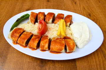Famous Urfa meat liver, ciger wrapped by lavash with roasted chili pepper, onion and sauce in...