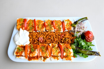 Famous Urfa meat liver, ciger wrapped by lavash with roasted chili pepper, onion and sauce in Sanliurfa, Turkey. Kuzu et ciger sis. Izgara dana bonfile, cop sis, kuzu pirzola. Karisik kebap, beyti keb