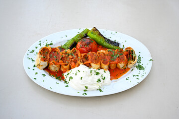 Famous Urfa meat liver, ciger wrapped by lavash with roasted chili pepper, onion and sauce in...