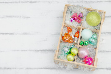 Trendy Kitschmas background. Vintage New Year balls, pink fir tree branches, silver garland