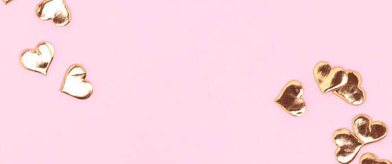 Banner with shiny golden hearts confetti scattered on a pink background.