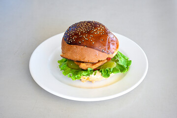 Big tasty burger with beef cutlet on a plate. Hamburger, cheeseburger with mushroom. Hamburger, Mexica, mushroom double burger.  Crispy chicken burger. With french fries, patates kizartmasi.