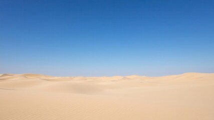 Vast and Serene Desert Landscape Under a Clear Blue Sky, Emphasizing the Beauty of Nature and the Harshness of Desert Environments and Sand Dunes