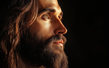 Obraz premium A striking, ultra-realistic stock photo of Jesus, with detailed facial features, long hair, and a soft beard, gazing upward against a solid black background.