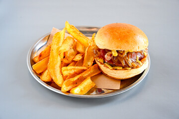 Big tasty burger with beef cutlet on a plate. Hamburger, cheeseburger with mushroom. Hamburger, Mexica, mushroom double cheddar  burger.  Crispy chicken burger. With french fries, patates kizartmasi.