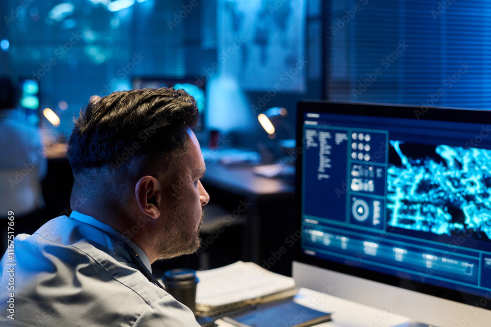 Aufkleber focus on mature male officer in uniform sitting by workplace and looking at computer screen with gra