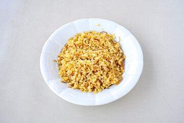 Traditional turkish bulgur pilaf with tomato sause in plate (Turkish name; bulgur pilavi, meyhane pilavi)
