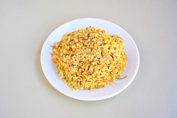 Traditional turkish bulgur pilaf with tomato sause in plate (Turkish name; bulgur pilavi, meyhane pilavi)