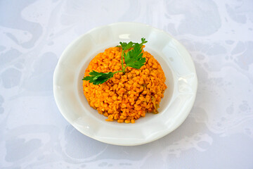 Traditional turkish bulgur pilaf with tomato sause in plate (Turkish name; bulgur pilavi, meyhane...