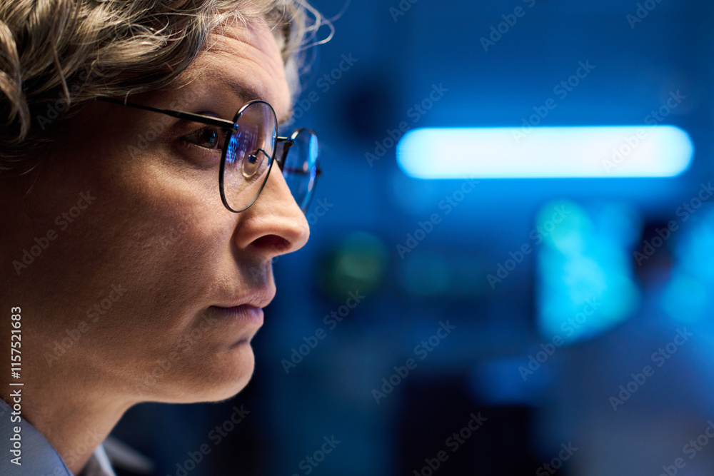 Poster Modern mature female officer of military command center in eyeglasses learning graphic data on computer screen