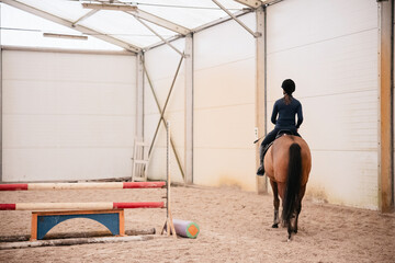 Hall for riding horses with obstacles