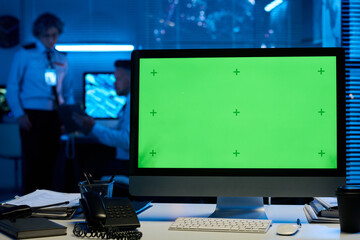 Blank chromakey screen of desktop computer standing on workplace of modern officer of military...