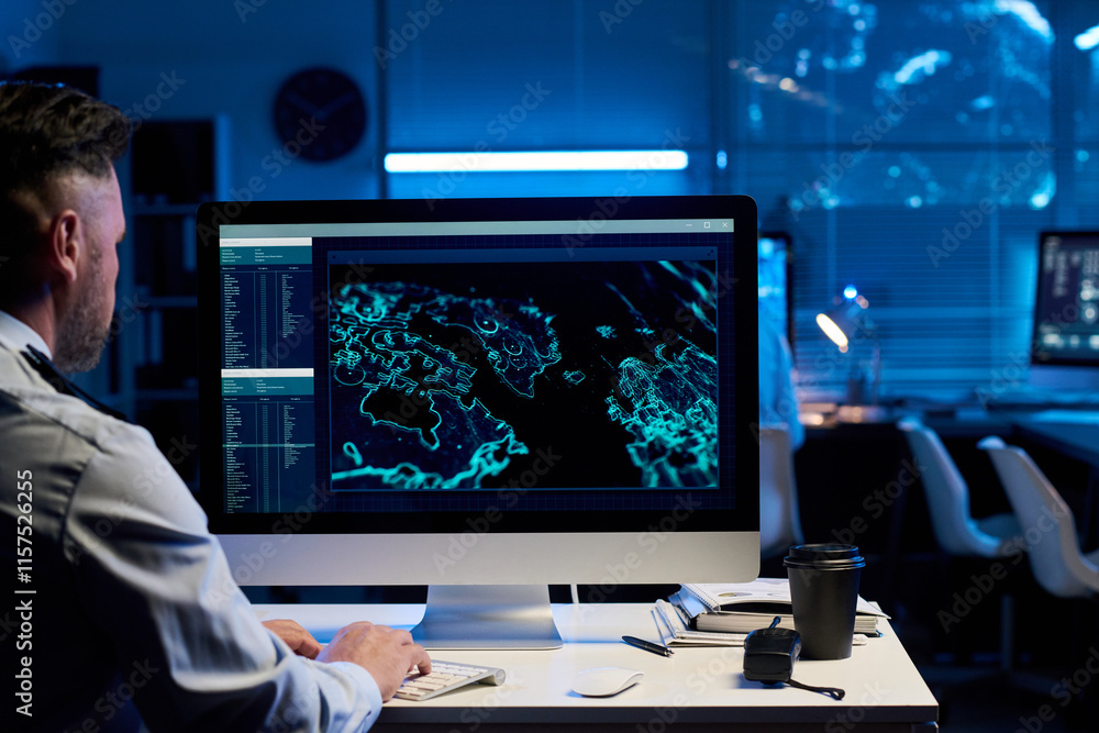 Leinwandbilder desktop computer with graphic military data on screen and mature male operator in uniform typing on 