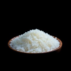 Raw white rice grains in a wooden bowl, isolated on a black background.