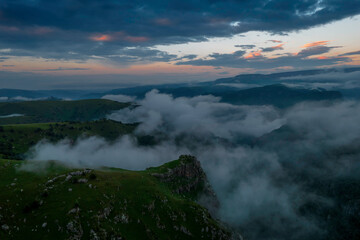 Mountains in the clouds, low clouds in a mountain valley. Landscape and nature of the North Caucasus