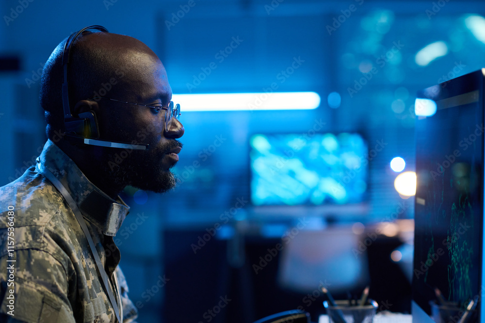 Aufkleber side view of serious male military operator in headset, eyeglasses and camouflage uniform looking at