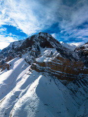 Beautiful aerial view of snowy peaks in a picturesque gorge. Landscape and nature of the North Caucasus