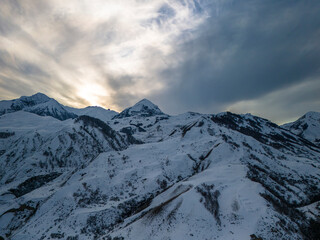 Beautiful aerial view of snowy peaks in a picturesque gorge. Landscape and nature of the North Caucasus