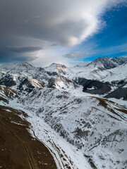 Beautiful aerial view of snowy peaks in a picturesque gorge. Landscape and nature of the North Caucasus