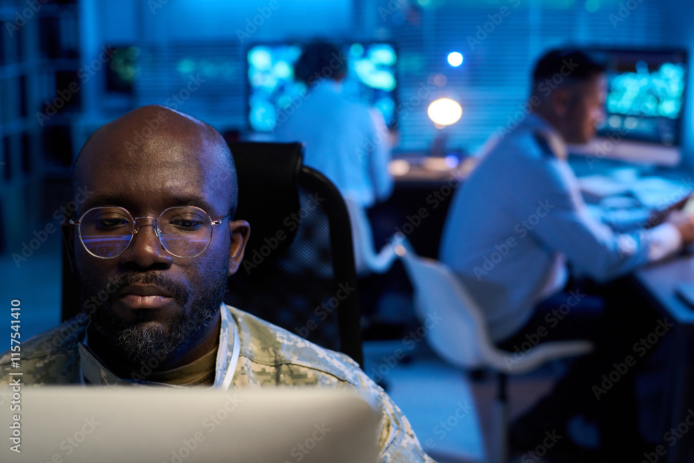 Aufkleber focus on young african american male officer in eyeglasses looking at screen of desktop computer wit