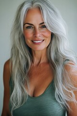 Naklejka premium Portrait of a Beautiful Senior Woman With Grey Hair, Smiling, Showing Clean Teeth, and Perfect Skin
