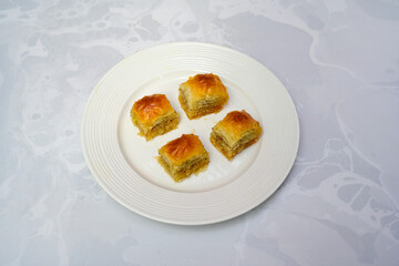 Turkish Dessert Sobiyet, havuc dilimi, midye baklava, mussels baklava and classic baklava with Pistachio . Cikolatali cevizli, fistikli soguk Baklava, top view.