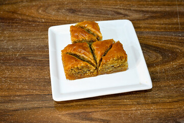 Turkish Dessert Sobiyet, havuc dilimi, midye baklava, mussels baklava and classic baklava with Pistachio . Cikolatali cevizli, fistikli soguk Baklava, top view.